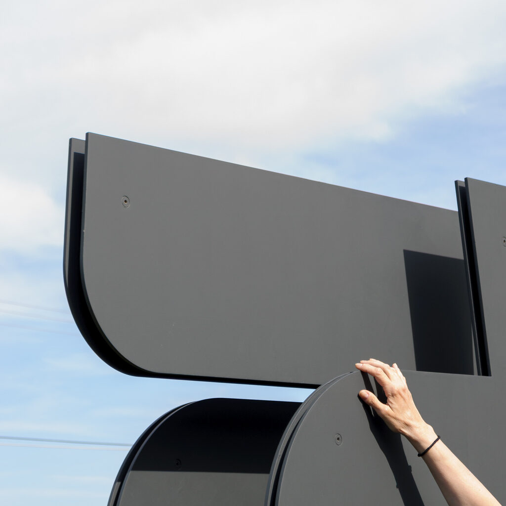 A hand is touching part of the artwork.