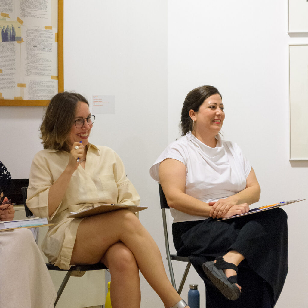 Two women smiling during a discussion circle
