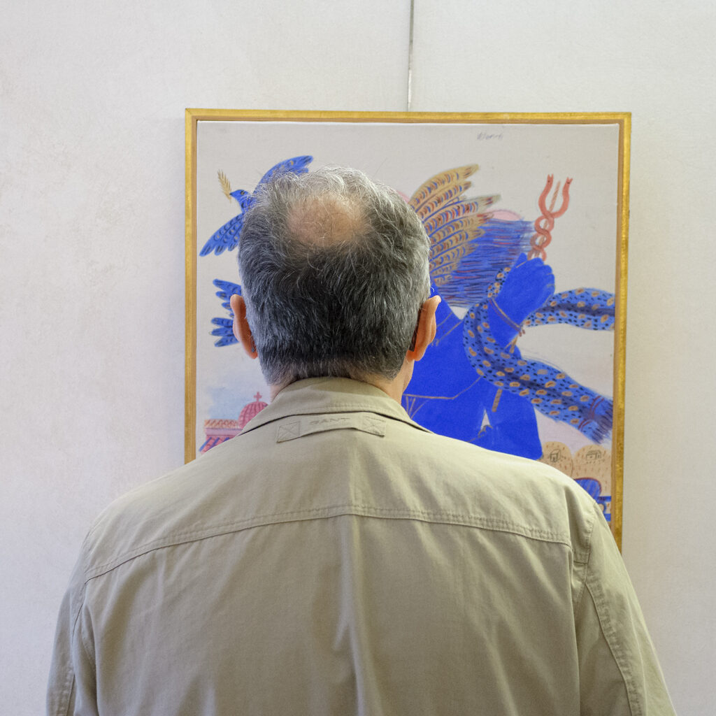 Man looking at painting with a blue figure