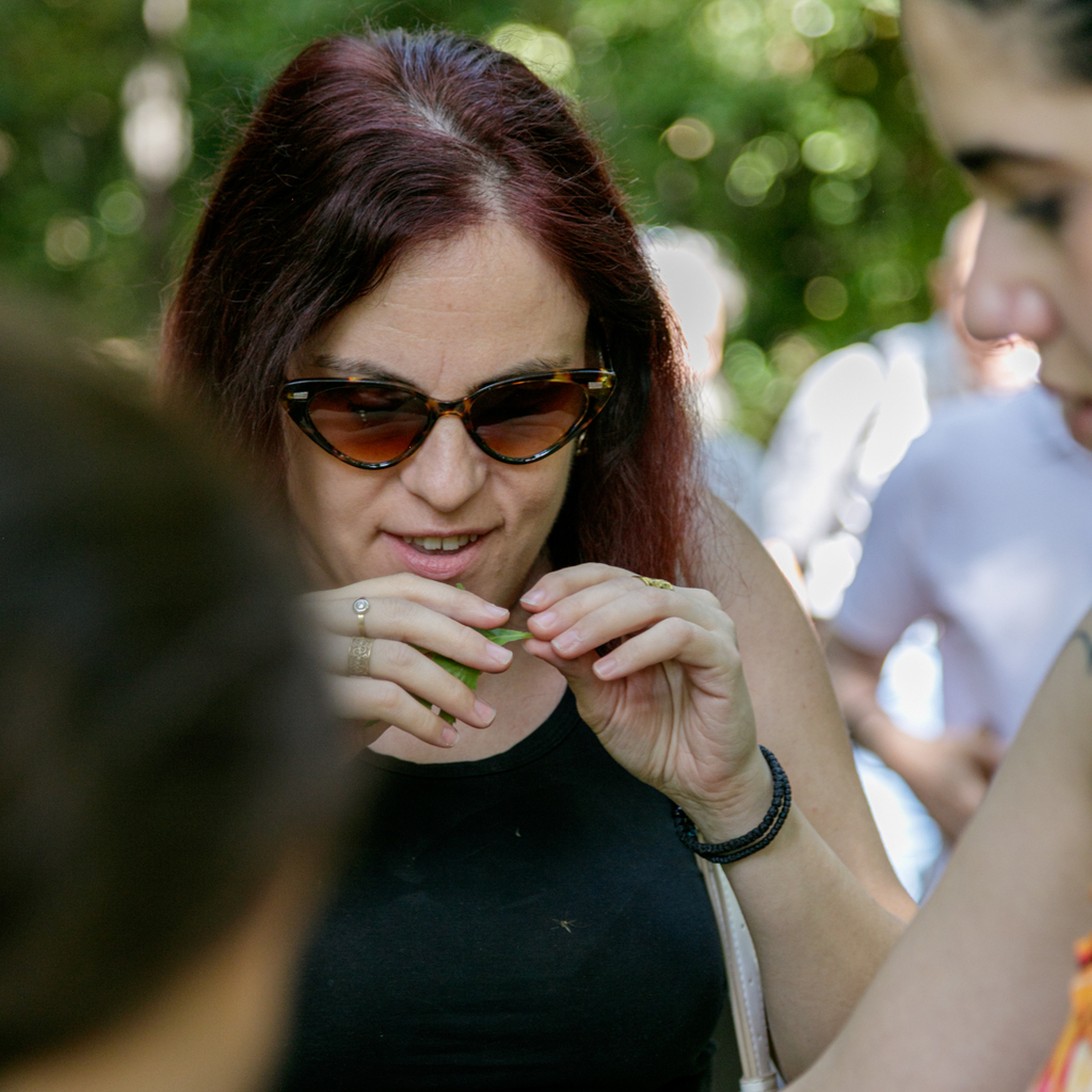 Participant explores a leaf by touch during the multisensory walk.