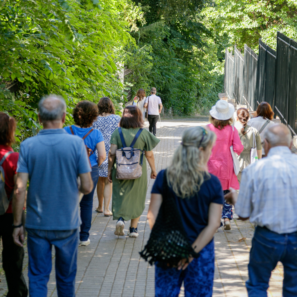 Participants walking along a path in the historic garden.
