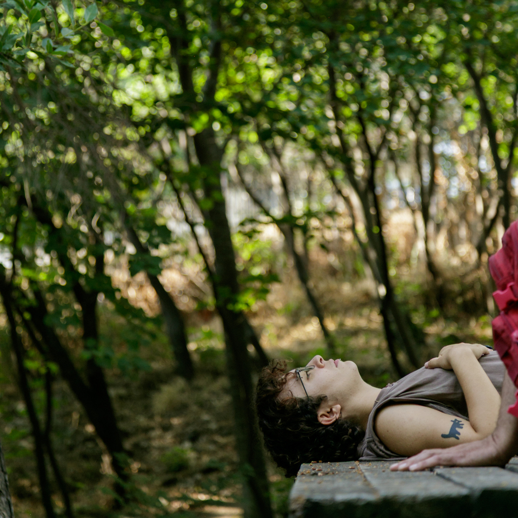 Participant lying down, listening to the sounds of the garden.